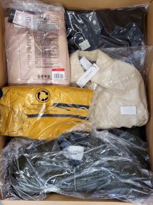 The photo shows a package with clothing in the category AJS.