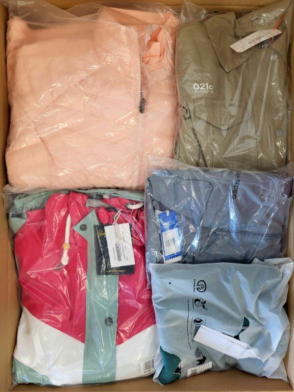 The photo shows a package with clothing in the category AJS.