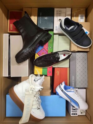 The photo shows a package with footwear in the category AS.