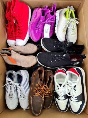 The photo shows a package with footwear in the category SH.