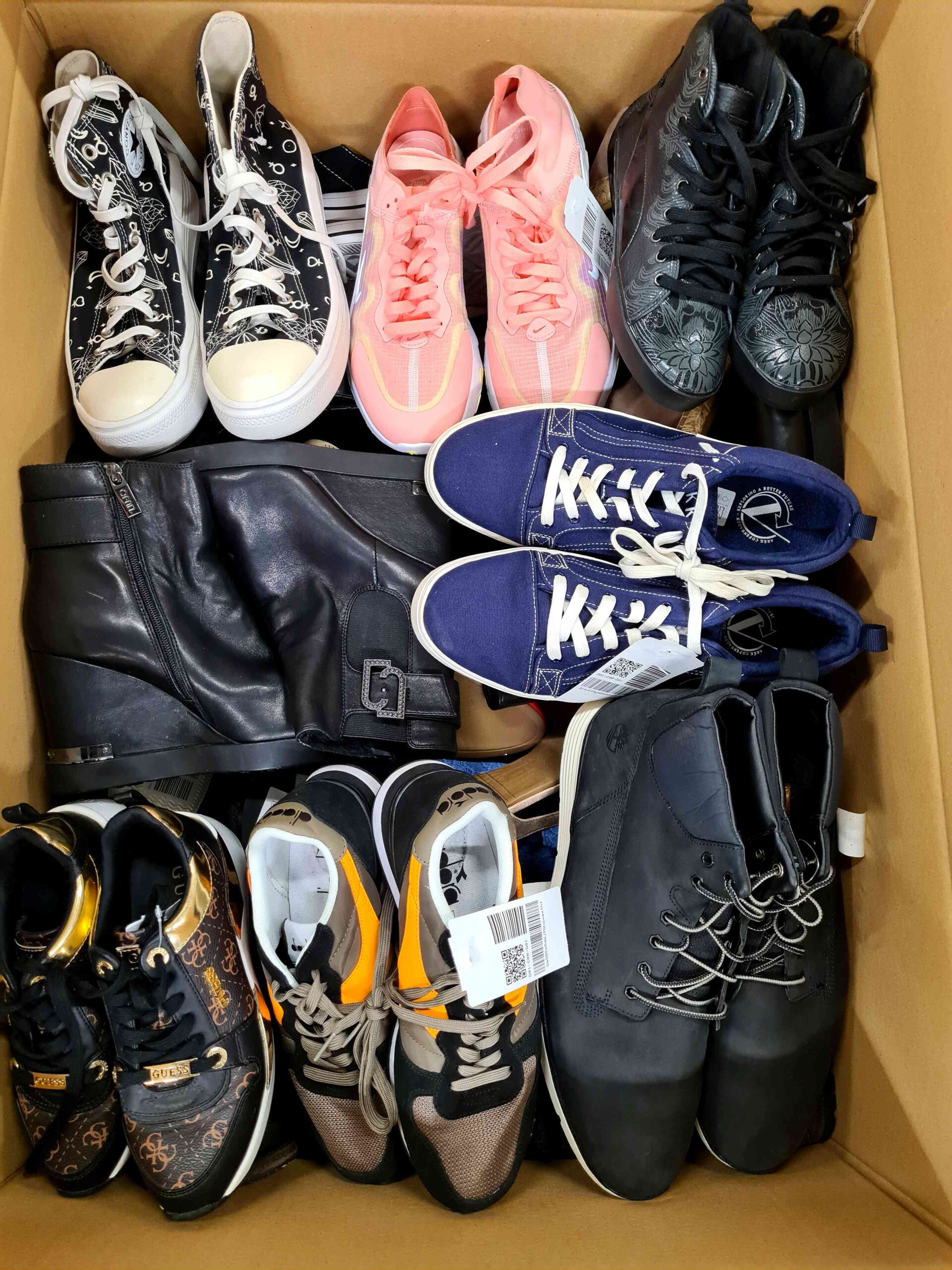 The photo shows a package with footwear in the category SH.