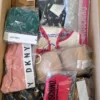 The photo shows a package with clothing in the category AU.