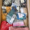 The photo shows a package with clothing in the category AU.