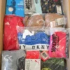 The photo shows a package with clothing in the category AU.