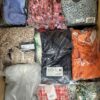 The photo shows a package with clothing in the category AR.