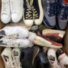 The photo shows a package with footwear in the category SH.