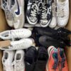 The photo shows a package with footwear in the category SH.
