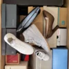 The photo shows a package with footwear in the category AS.