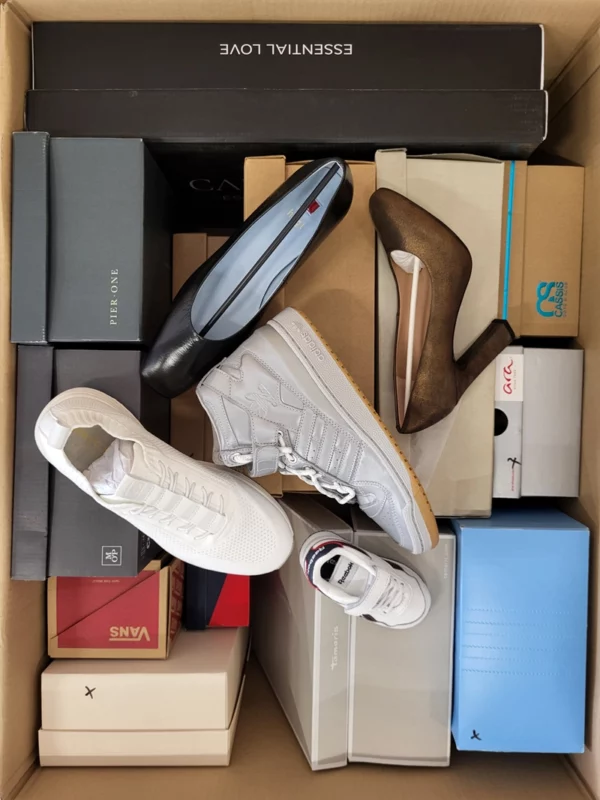 The photo shows a package with footwear in the category AS.