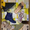 The photo shows a package with footwear in the category SM.