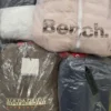 The photo shows a package with clothing in the category AJW.