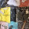 The photo shows a package with clothing in the category AW.