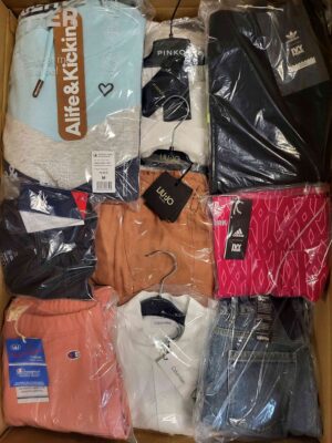 The photo shows a package with clothing in the category AW.