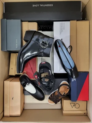 The photo shows a package with footwear in the category AS.