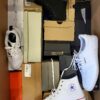 The photo shows a package with footwear in the category BS.