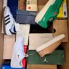 The photo shows a package with footwear in the category BS.