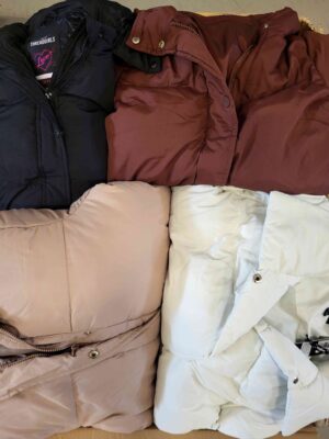 The photo shows a package with clothing in the category TJ.