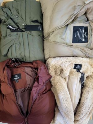 The photo shows a package with clothing in the category TJ.
