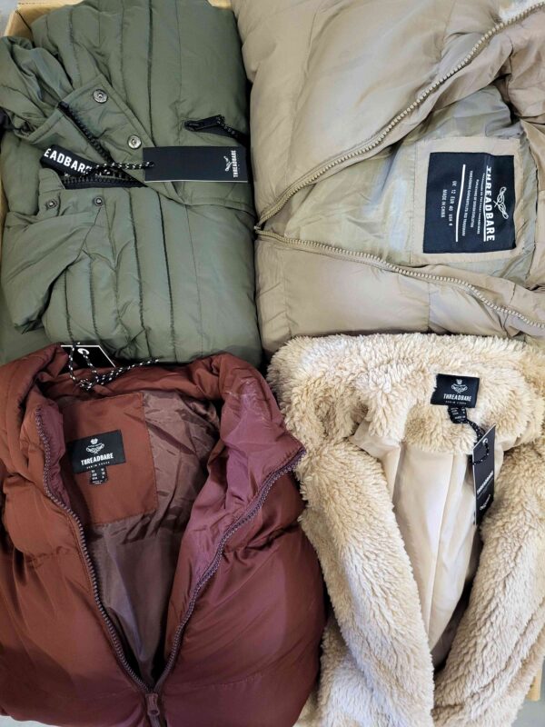 The photo shows a package with clothing in the category TJ.