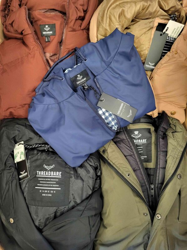 The photo shows a package with clothing in the category TJ.