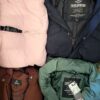 The photo shows a package with clothing in the category TJ.