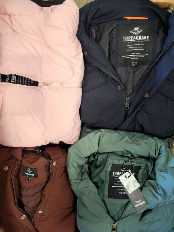 The photo shows a package with clothing in the category TJ.