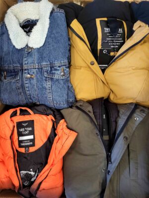 The photo shows a package with clothing in the category TJ.