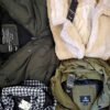 The photo shows a package with clothing in the category TJ.