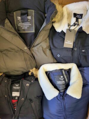 The photo shows a package with clothing in the category TJ.