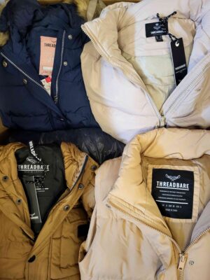 The photo shows a package with clothing in the category TJ.