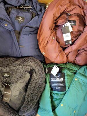 The photo shows a package with clothing in the category TJ.
