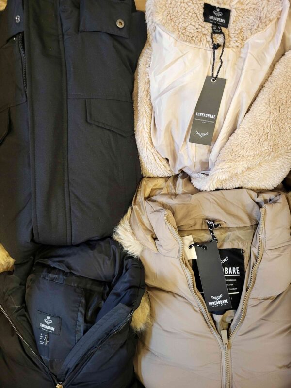 The photo shows a package with clothing in the category TJ.