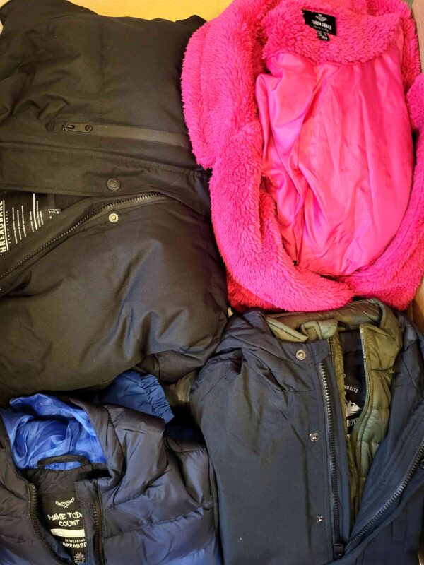 The photo shows a package with clothing in the category TJ.