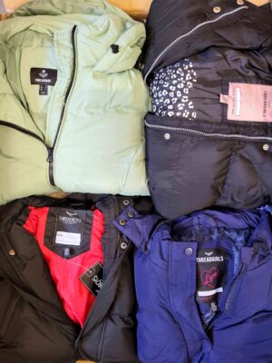 The photo shows a package with clothing in the category TJ.