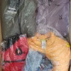 The photo shows a package with clothing in the category AJS.