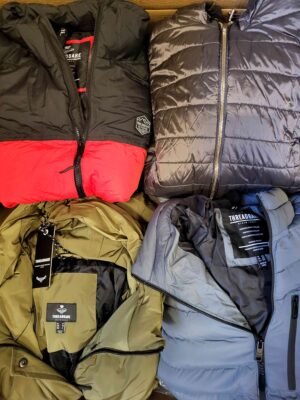 The photo shows a package with clothing in the category TJ.