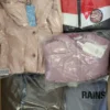 The photo shows a package with clothing in the category AJS.