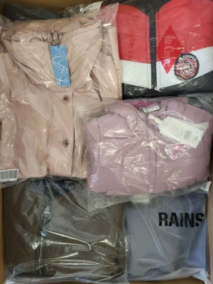 The photo shows a package with clothing in the category AJS.