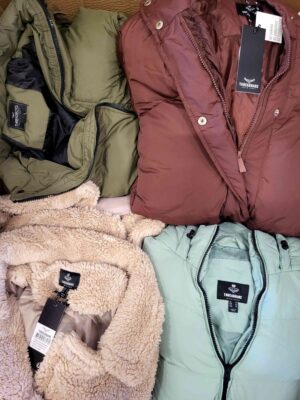The photo shows a package with clothing in the category TJ.