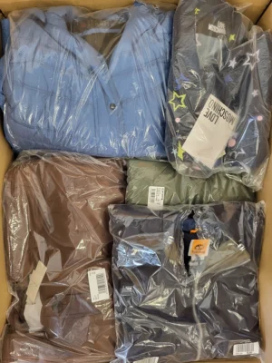 The photo shows a package with clothing in the category AJS.