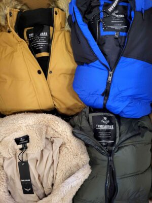 The photo shows a package with clothing in the category TJ.