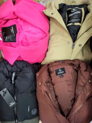 The photo shows a package with clothing in the category TJ.
