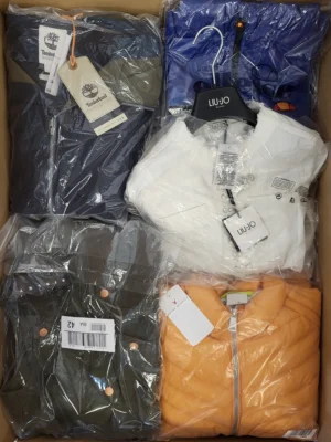 The photo shows a package with clothing in the category AJS.