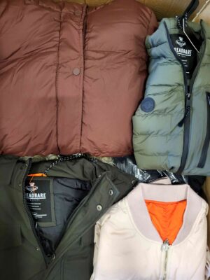 The photo shows a package with clothing in the category TJ.