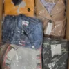 The photo shows a package with clothing in the category AJS.
