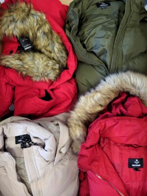The photo shows a package with clothing in the category TJ.