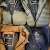 The photo shows a package with clothing in the category TJ.