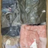 The photo shows a package with clothing in the category AJS.