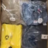The photo shows a package with clothing in the category AJS.