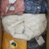 The photo shows a package with clothing in the category AJS.
